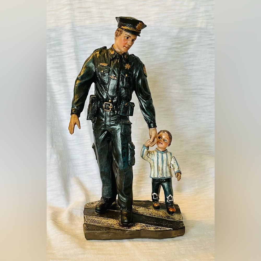 Police Officer Helping Child Figurine